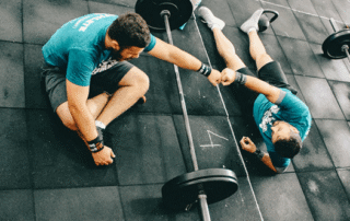Workout partners giving each other a fist bump