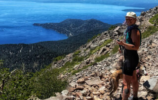 Christine hiking with dog overlooking Lake Tahoe